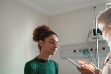 A photo of a person speaking to a GP